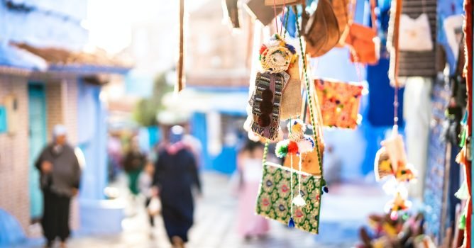 Handcraft textile bags and souvenirs at street market along Chefchaouen streets in Morocco